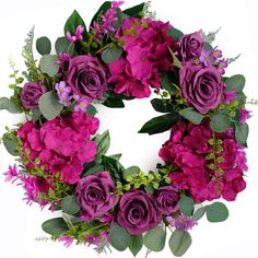 a wreath with purple flowers and greenery