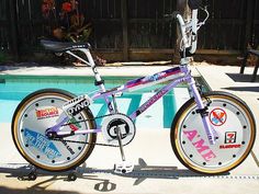 a purple bike parked next to a swimming pool