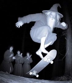 a man on a skateboard in the air with other people around him behind him