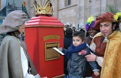 a group of people standing around a red box