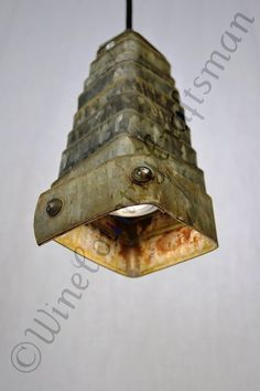 an old rusty light fixture hanging from a ceiling