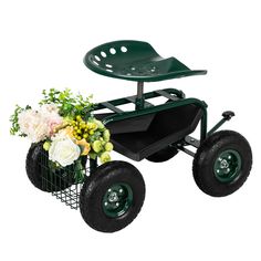 a green garden cart with flowers in it