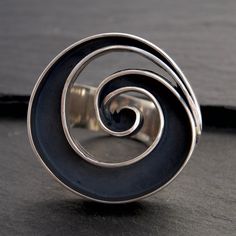 A bold & unique design to invite the significance of spirals into your day-to-day. Spirals represent the journey and change of life as it unfolds. They are a powerful symbol that have been used in ancient cultures around the world since prehistory in order to represent expansive, cosmic wisdom and the universal pattern of growth and evolution, eternity and continuity.Wearing spiral jewelry brings the presence of this prehistoric symbol into daily life, inviting oneself to explore the infinity of Modern Jewelry With Unique Spiral Design, Handmade Spiral Rings With Unique Style, Modern Gold Spiral Ring, Unique Spiral Metal Rings, Change Of Life, Unique Spiral Bronze Jewelry, Large Rings, Cultures Around The World, Spiral Jewelry