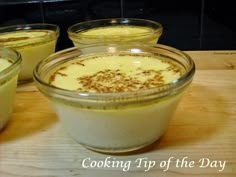 three desserts in glass containers sitting on a table