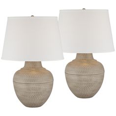 two lamps sitting next to each other on a white background