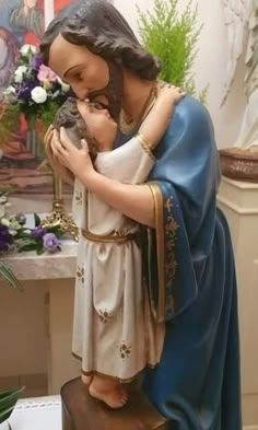 a statue of the virgin mary holding a baby jesus