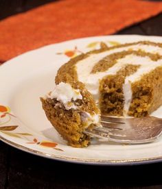 a piece of carrot cake on a plate with a fork