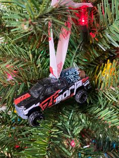 a toy car ornament hanging from a christmas tree