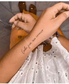 a woman with a tattoo on her arm saying, i love you more than others