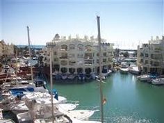 boats are parked in the water near buildings