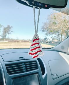 a car dashboard with an ornament hanging from the dash board