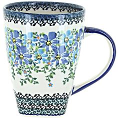 a blue and white coffee cup with flowers on it