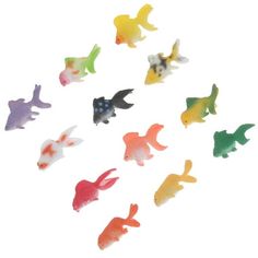 small plastic fish are shown on a white background