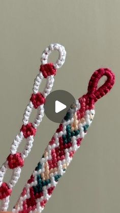 two crocheted bracelets are being held by someone's hand with scissors