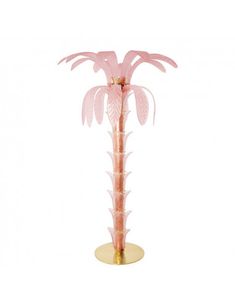 a pink palm tree on a gold base with leaves and branches in the shape of flowers