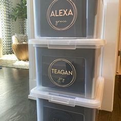 three plastic storage containers stacked on top of each other in front of a wooden floor