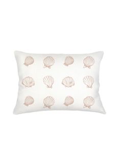 a white pillow with pink seashells printed on the front and back, along with a light pink border