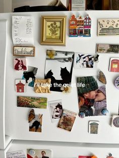 a refrigerator covered in magnets and pictures