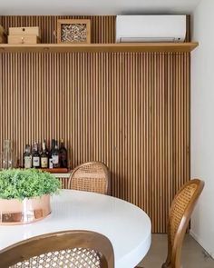 an instagram photo of a dining room table and chairs with plants on the counter