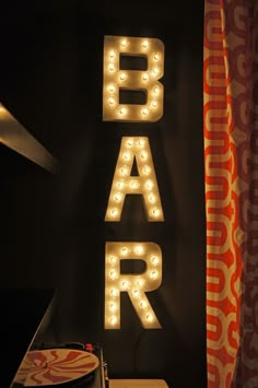 a sign that says bar with lights on it