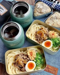 four containers filled with food sitting on top of a table