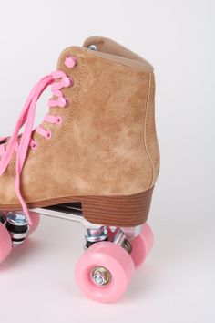 a pair of roller skates with pink wheels and laces on the bottom, against a white background