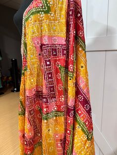 Experience the beauty of traditional Phulkari style with our Multicolor Dupatta. Made with a soft and luxurious silk finish, this dupatta features real mirror accents and stunning designs. Its heavy-weight construction makes it perfect for special occasions like Navaratri. Elevate your wardrobe with this must-have accessory. Approx 2.5 meters length Bohemian Sharara With Dupatta In Traditional Drape, Bohemian Sharara With Dupatta And Traditional Drape, Silk Traditional Wear With Gota Work, Bohemian Anarkali Set With Gota Work, Bohemian Chanderi Anarkali Set With Gota Work, Bohemian Silk Sharara With Dupatta, Multicolor Semi-stitched Lehenga With Motifs, Semi-stitched Multicolor Lehenga With Motifs, Bollywood Style Multicolor Anarkali Set For Festive Season