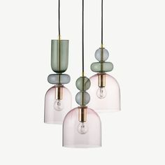 three glass pendant lights hanging from the ceiling