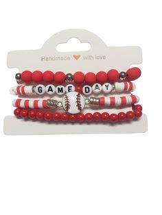 three red and white bracelets with baseball charms on each beaded strand, featuring the words game day