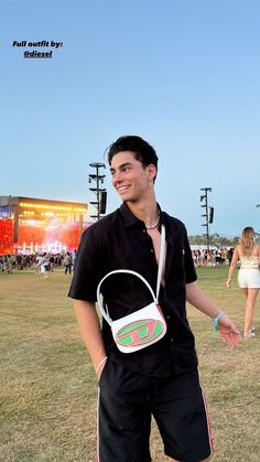 a man in black shirt holding a white bag