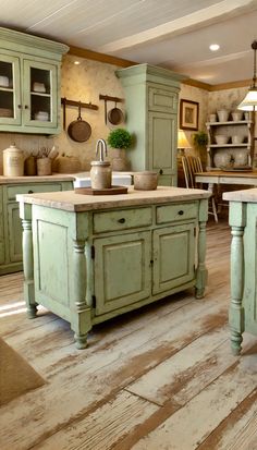 an old fashioned kitchen with wooden floors and green cabinets, painted in pale blue tones