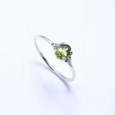 RING DETAIL Metal : 925 sterling silver Center stone : Peridot & cubic zirconia Shape : Oval Stone size; 6x4mm CUBIC ZIRCONIA We just utilize the best cubic zirconia. With shading, lucidity and phenomenal slice to coordinate common precious stone guidelines, our fine quality cubic zirconia gives the ideal degree of brightness, sparkle and fire. PERIDOT Peridot stones are birthstones for August, September and October... furthermore, make lovely valuable jewelry.Using Peridot gemstones Peridot wil Dainty Peridot Promise Ring, Green Sterling Silver Crystal Promise Ring, Green Crystal Birthstone Ring In Sterling Silver, Silver Peridot Round Rings, Silver Peridot Birthstone Ring, Peridot Birthstone Ring In White Gold, Silver Peridot Promise Ring, Silver Peridot Ring With Birthstone, Silver Peridot Rings For Promise