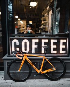 a bicycle parked in front of a coffee shop