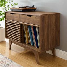 a record player sitting on top of a wooden cabinet