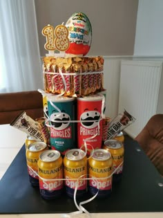 a cake made to look like cans of beer and snacks on top of each other