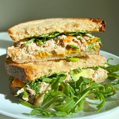 a sandwich with meat and vegetables on a plate