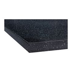 a black counter top with white speckles on the edges and one corner missing