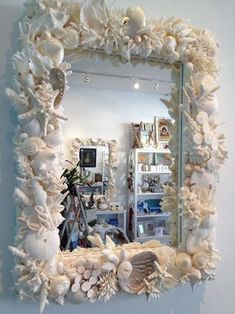 a mirror that has shells and seashells on it