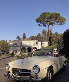 an old car parked in front of a house