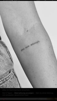 a person's arm with the words you are enough written on it, in black and white