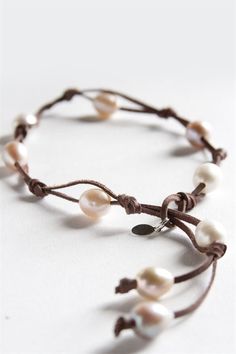 Authentic boho style with a twist! Our 9 Fresh Water Pearl Wrap features nine white freshwater pearls set in a beautiful brandy-colored leather with pearl sizes varying from 6 - 14mm. This chic jewelry was featured in Accesories Magazine as the Best Friendship Bracelet and, just like a good friend, is a rare find. Wrap twice to wear it as a bracelet or fully extend to wear as a choker, as it is 19" long at its longest point. Choker length is adjustable from 15"-19". Wrap Armband, Bracelet Cordon, Bracelets Handmade Diy, Pola Gelang, Handmade Wire Jewelry, Homemade Jewelry, A Bracelet, Chic Jewelry, Bracelet Crafts