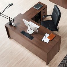 an office desk with a chair, computer monitor and laptop on it is shown from above