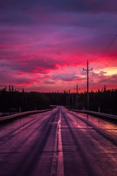 the sun is setting on an empty highway