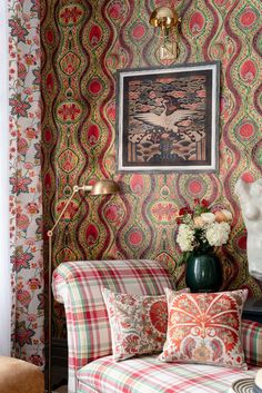 a living room filled with lots of furniture and walls covered in colorful wall coverings