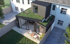 an aerial view of a house with grass growing on the roof and decking area