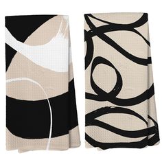 two towels with black and white designs on them, one is folded to the side