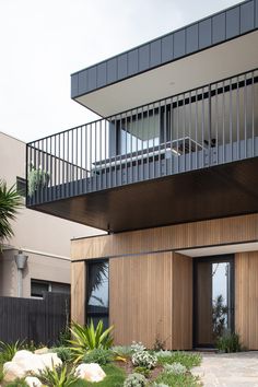 a modern house with wooden siding and balconies