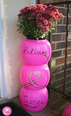 a pink vase with flowers in it that says believe, love and curvy