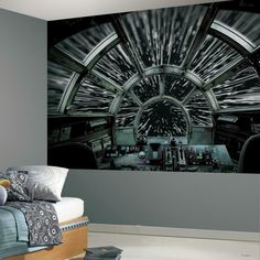 a bedroom with a star wars theme painted on the wall