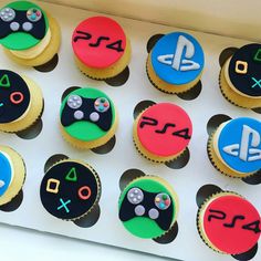 the cupcakes are decorated with video game controllers and numbers on them, as well as other decorations